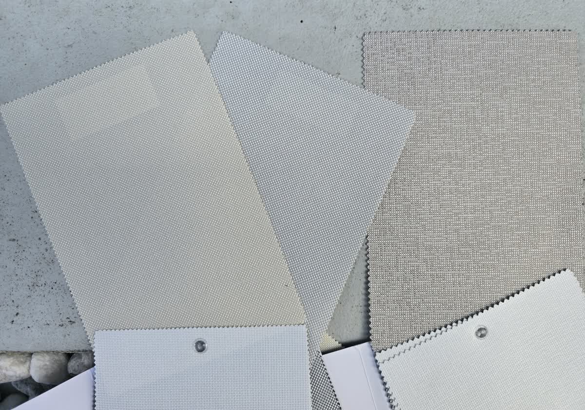 Roller blind fabric samples spread out, showing sunscreen weaves, linen textures and blockout swatches